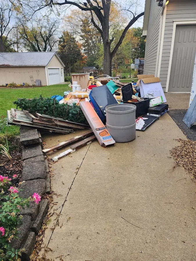 Dumpster being loaded with debris for Roofing Dumpster Rental in Huntsville